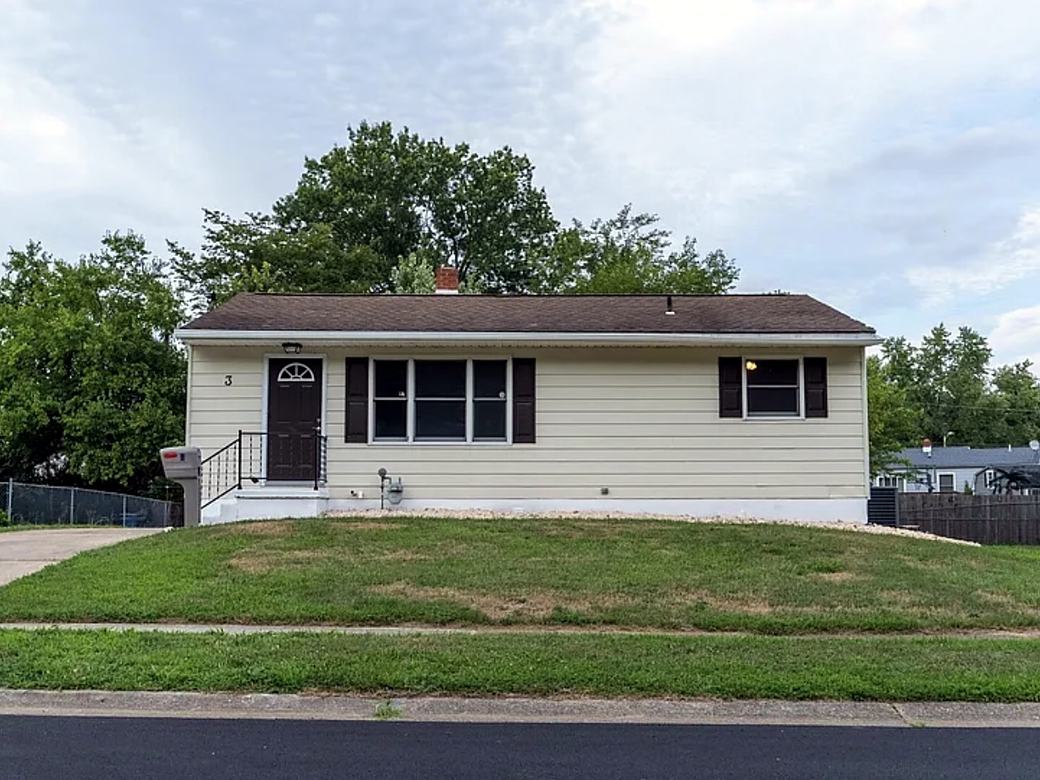 Same ranch with a new front door, black shutters and a black railing