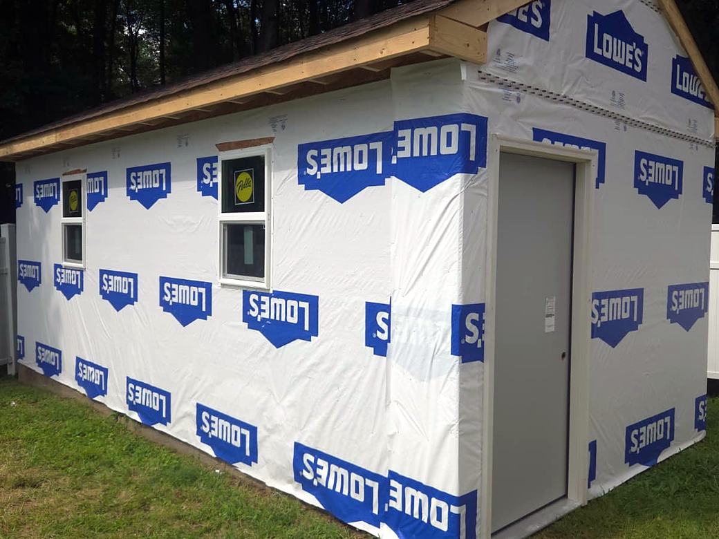 Shed wrapped with a door installed