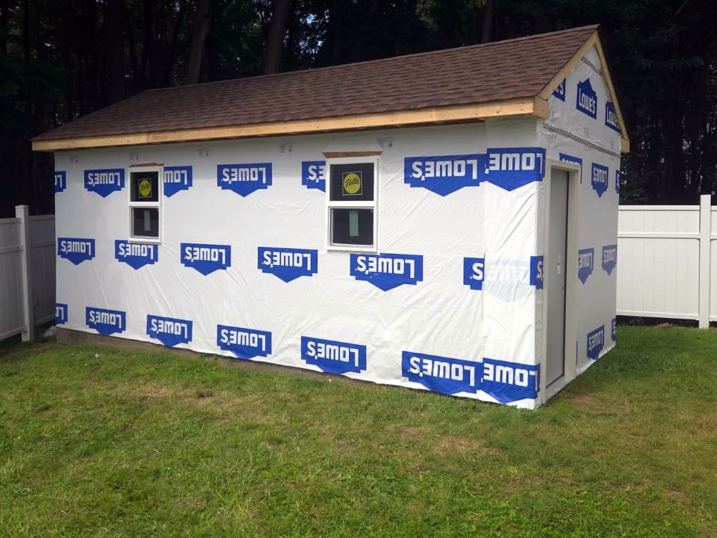 Shed sheathed and wrapped with windows and door